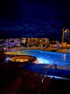 a pool with a lot of umbrellas on top of it at Delight's Hot Springs Resort in Tecopa