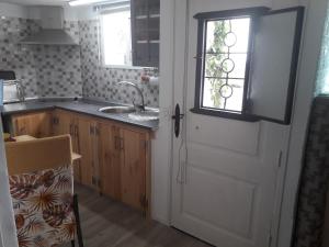 a kitchen with a white door and a sink at Apartamento Trini in La Jaca