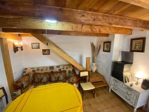 a bedroom with a yellow bed and a couch at Altea Old Town Cottage in Altea