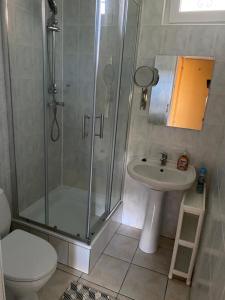 y baño con ducha, aseo y lavamanos. en Apartamenty przy plaży Graniczna 4, en Pobierowo