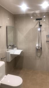 a bathroom with a toilet and a sink and a shower at Vila Gama in Lozenets +57 photos