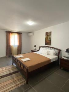 a bedroom with a large bed with two towels on it at Mama'sEvdokia Apartment in Rhodes Town