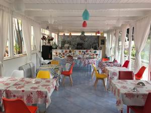 a restaurant with tables and chairs and a counter at Villa Scotillo Boutique Hotel in Agropoli