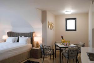 a bedroom with a bed and a table with chairs at Vila Gama in Lozenets