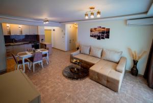 a living room with a couch and a table at Marc Moonlight Residence in Mamaia