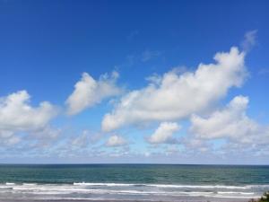 a beach with the ocean and a cloudy sky at Mar del Este in San Bernardo