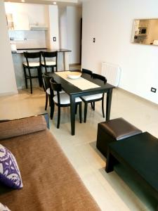 a living room with a black table and chairs at Mar del Este in San Bernardo