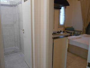 a bathroom with a shower and a kitchen with a sink at Villa Fotis in Ligia +43 photos
