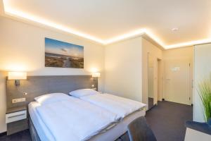 Ένα ή περισσότερα κρεβάτια σε δωμάτιο στο Hotel Mukran