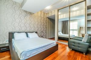 a bedroom with a bed and a chair at Megafun Residance B1 in Baku +51 photos