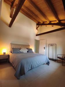 a bedroom with a large bed with a wooden ceiling at Casa Carmina Hostel in Muros de Nalón