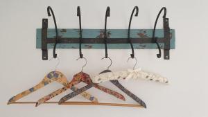 a group of four hangers hanging on a wall at Argyll House Bed and Breakfast in Westleton