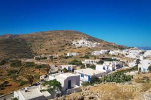 an aerial view of a town on a hill at Kastro Elegant House in Síkinos