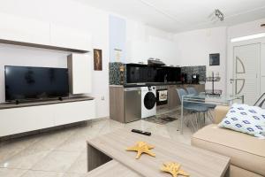 a living room with a tv and a living room with stars at Luxury Dream House in Limenaria