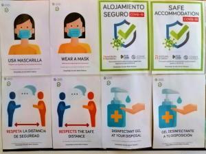 a display of posters urging people to wear a mask at Hospedaje Botin in Santander
