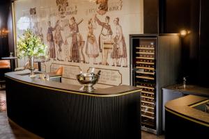 a bar in a room with a wall with drawings at Amedia Plaza Wels, Trademark Collection by Wyndham in Wels