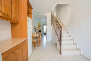 a kitchen and dining room with a staircase in a house at Ionion Apartments & Studios in Nydri