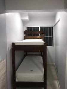 a small bunk bed in a small room at Apart Hotel CTC - Edifício Araras in Caldas Novas