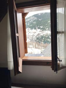 a window with a view of a snow covered mountain at Casa Planominguero in Taull