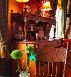 a wooden table with a vase with flowers in it at American River Inn in Georgetown