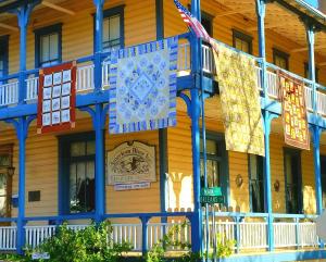 a building with colorful flags on the side of it at American River Inn in Georgetown