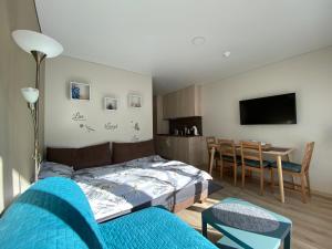 a bedroom with a bed and a dining room at Kitas krantas in Juodkrantė