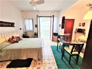 a bedroom with a bed and a table and a desk at Lovely House in Santa Margherita Ligure