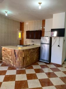 a kitchen with a counter and a refrigerator in it at Ashour Tower Ramy Abdulla For Families only in Marsa Matruh