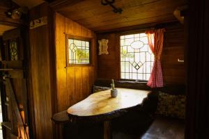 a small room with a wooden table and a window at Alpacas Off Grid - House Truck in Takaka