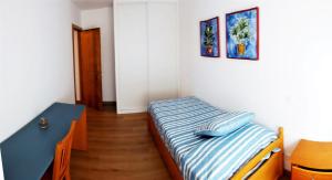 a small bedroom with a bed and a table at Bonus Dei - 5934 in Isla