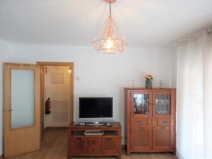 a living room with a television and a cabinet at Bonus Dei - 5934 in Isla