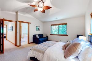 a bedroom with a bed and a ceiling fan at Creekside Retreat in Rockaway Beach +26 photos