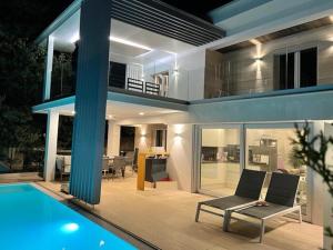 a house with a swimming pool in front of it at VILLA OD MOORE STARIGRAD in Starigrad-Paklenica
