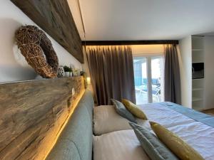 a bedroom with a large bed with a wooden headboard at VILLA OD MOORE STARIGRAD in Starigrad-Paklenica +28 photos