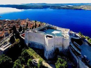 an aerial view of a building next to the water at The Palace Mattiazzi Room in Šibenik