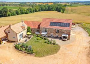 an aerial view of a house with solar panels on the roof at Chambre d'hôtes de la Fontagrille in Épineuil-le-Fleuriel