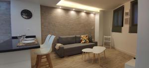 sala de estar con sofá, mesa y sillas en Rual Centro apartamento en Ronda