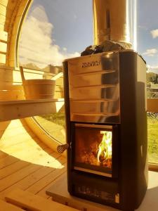 a stove with a fire in it on a deck at Willa Tatrzański Zomecek in Kościelisko