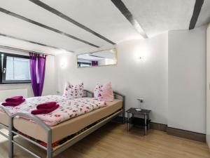 a bedroom with a bed with pink pillows on it at Cosy apartment in Grevesmühlen with parking in Grevesmühlen