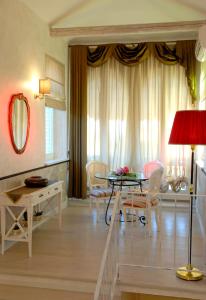 a living room with a table and chairs at Villa Helvetia in Grottammare