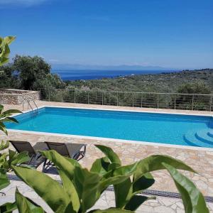 a swimming pool with a view of the ocean at Electra Villa & Pool Studios in Gaios