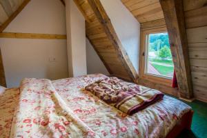 a bed in a room with a large window at Maple village in Žabljak