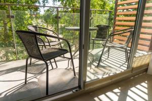 two chairs and a table on a porch at Apartamenty Brzask-Dawn, Bryza-Breeze - Osiedle Polanki in Kołobrzeg