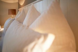 a close up of a bed with white pillows at Domizil Gols, Studios Am Anger in Gols