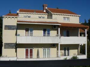 a large apartment building with a balcony at Apartments Mira in Cavtat