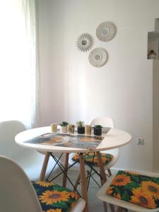 a white table with chairs and a table with plants on it at Apartament pod Chełmcem in Szczawno-Zdrój