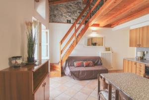 a kitchen and a living room with a couch at La Casa del Porto in Domaso