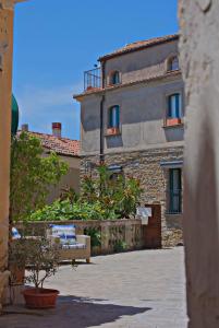 a large stone building with a bench in front of it at Il Fascino del Borgo in Castellabate