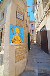 a painting of a woman on the side of a building at Il Fascino del Borgo in Castellabate