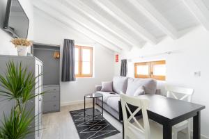 a living room with a couch and a table at Jardines Villaverde in Villaverde de Pontones